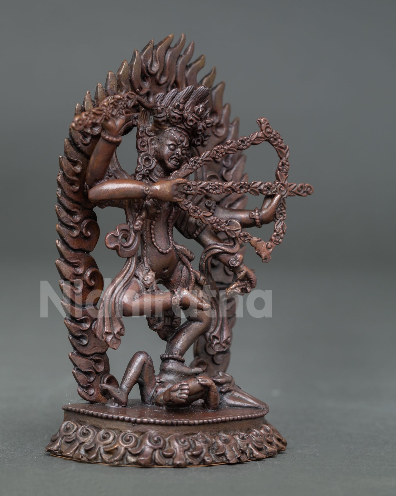 Side view of Kurukulla oxidized copper artwork with lotus base flame halo and symbolic Buddhist details