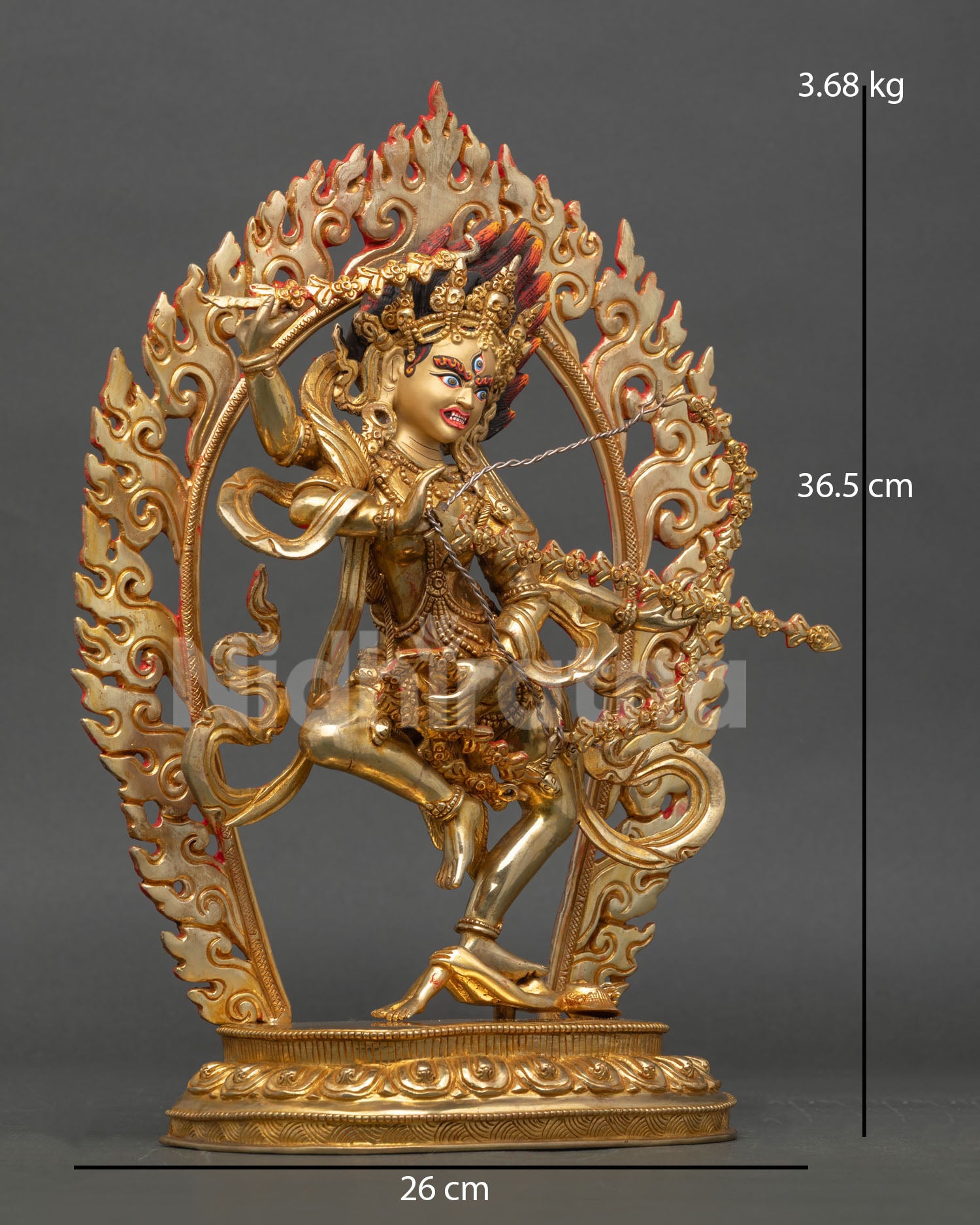 Side view of Kurukulla statue in dynamic standing posture upon lotus throne holding hook noose bow and flower arrows with ritual detail