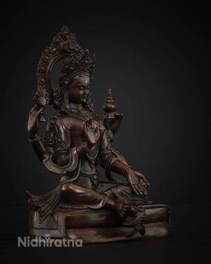 Side view of the Lakshmi statue seated on a lotus flower with four arms symbolizing Dharma, Kama, Artha, and Moksha