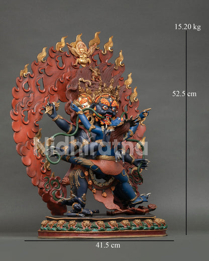 Side view of Mahachakra Vajrapani Yidam statue with consort, blazing halo, tiger skin garment, and carved lotus pedetsal.