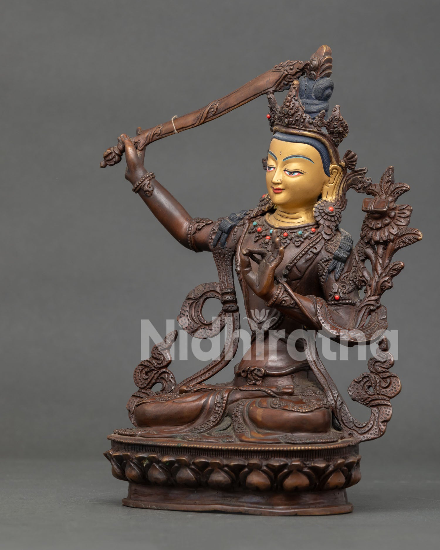 Side view of Manjushri Bodhisattva holding flaming wisdom sword and Prajnaparamita on lotus flower