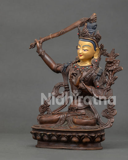 Side view of Manjushri Bodhisattva holding flaming wisdom sword and Prajnaparamita on lotus flower