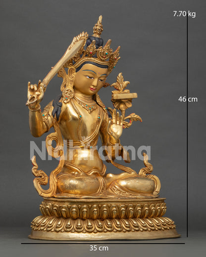 Side view of Manjushri statue holding flaming sword of wisdom and utpala lotus with Prajnaparamita Sutra