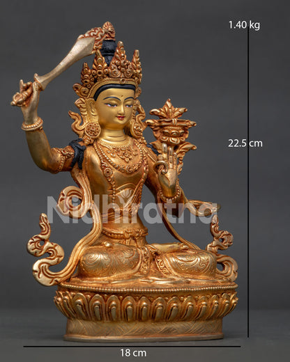 Side view of Manjushri statue holding flaming wisdom sword and utpala flower lotus