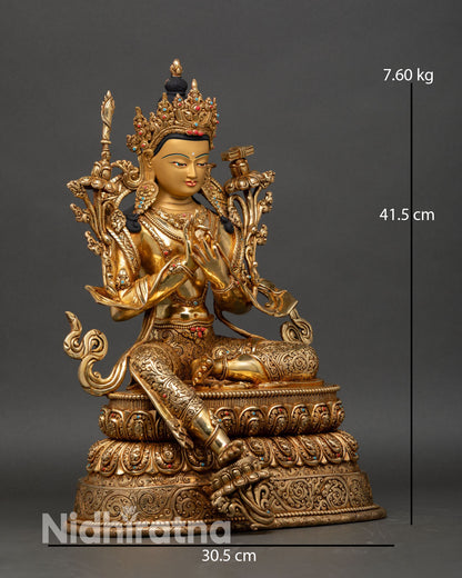 Side view of Manjushri statue showing utpala flower, wisdom sword, Prajnaparamita scripture, and intricately carved floral garments