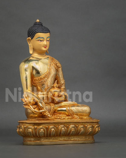 Side view of Medicine Buddha sculpture showing the sacred Myrobalan plant, healing nectar bowl, and floral carvings on the monk robe.