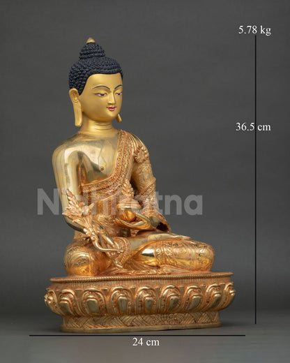 Side view of Medicine Buddha statue with flowing monastic robes and finely detailed Nepalese metalwork
