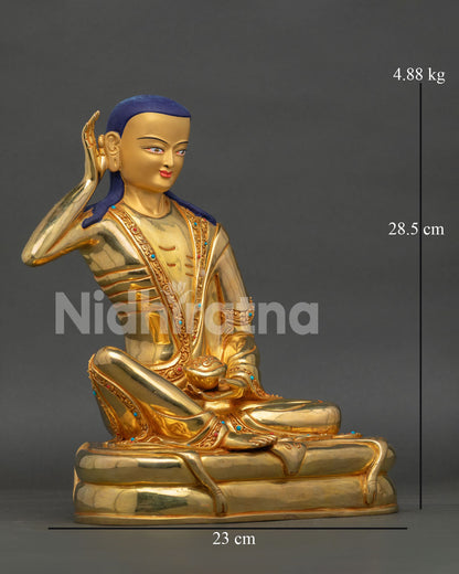 Side view of Milarepa sculpture, featuring deer skin pedestal kapala and traditional Himalayan craftsmanship