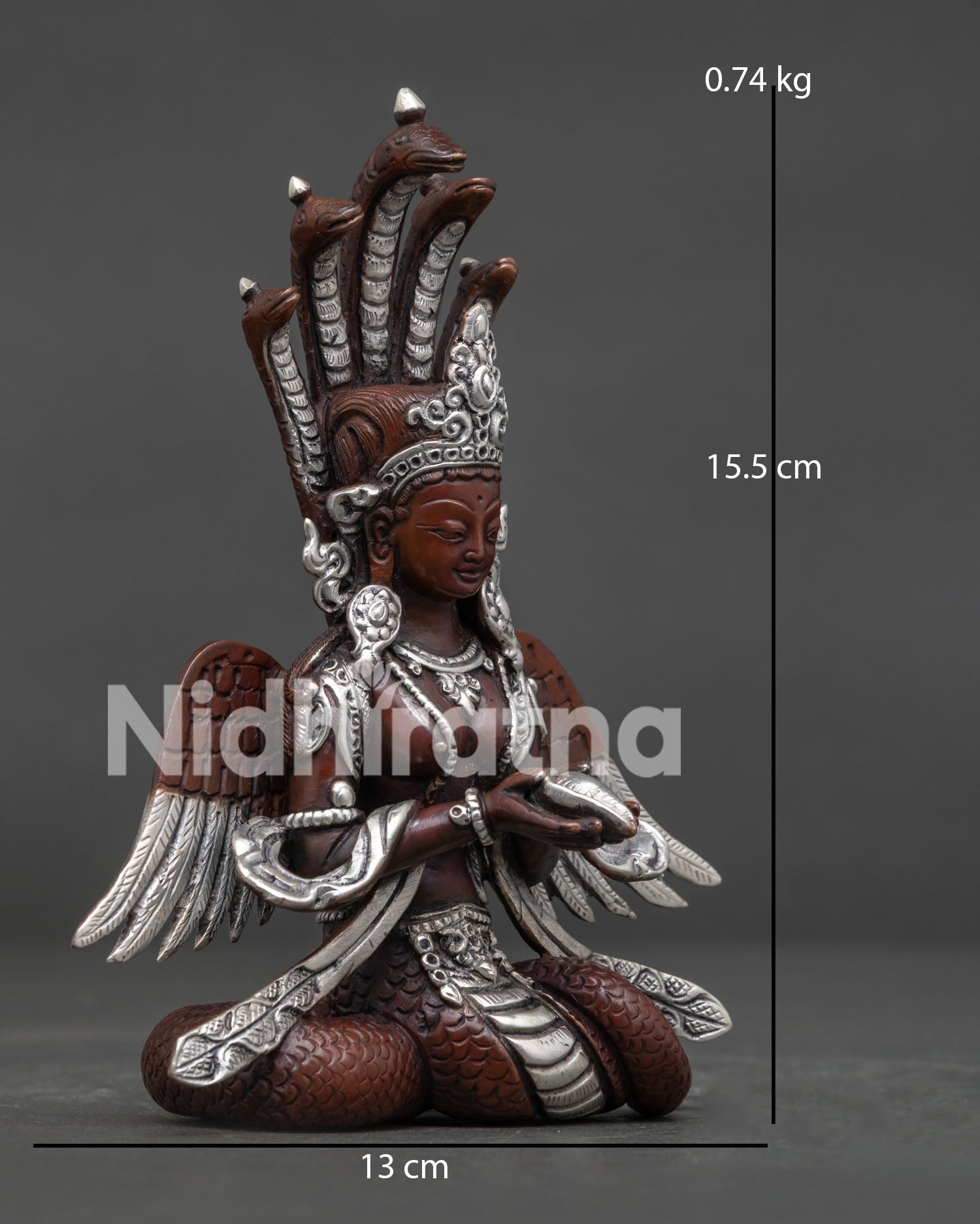 Side view of Naga Kanya statue, holding a conch shell with flowing robes and celestial wings