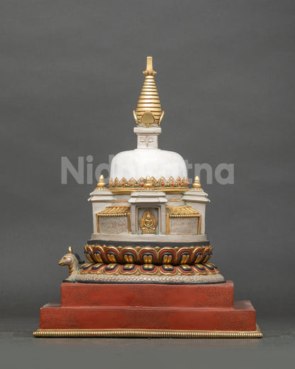 Side view of Newari handcrafted Himalayan stupa with coiled serpent on lotus base and red double pedestal