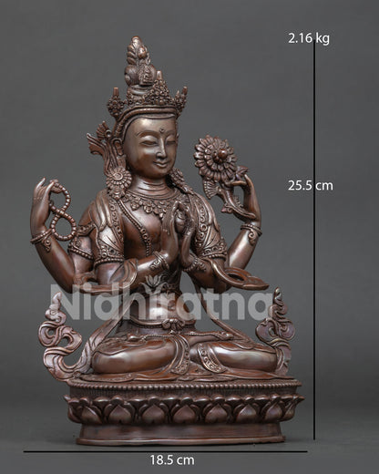Side view of oxidized copper Chenrezig Buddhist statue seated on a lotus pedestal