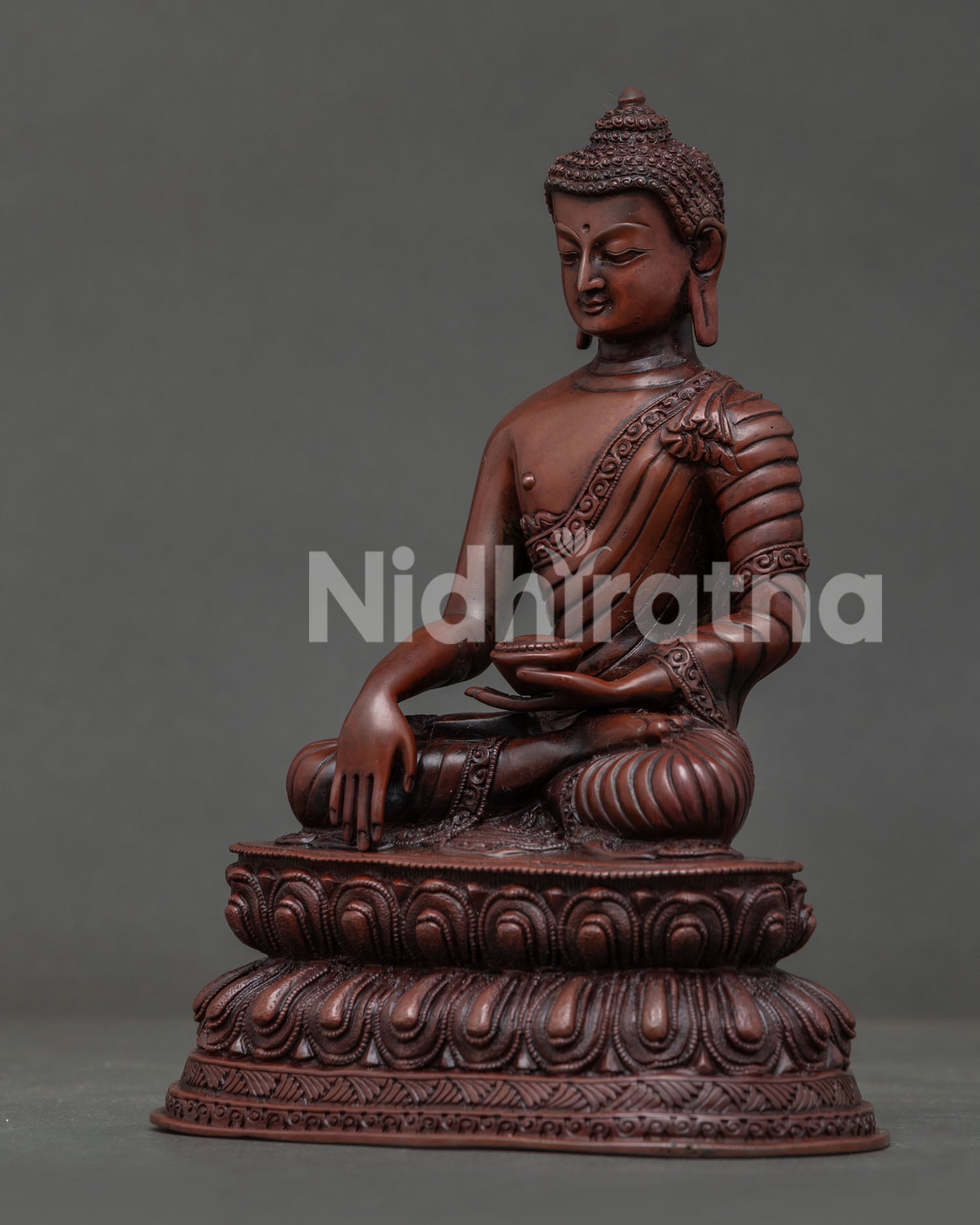 Side view of oxidized Shakyamuni Buddha statue on double lotus throne handcrafted in Nepal.