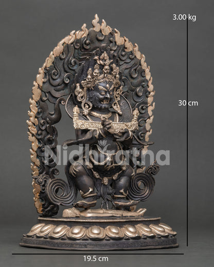 Side view of Sakya Mahakala holding scripture, knife in right hand and skull cup in left, detailed lost-wax copper Buddhist statue