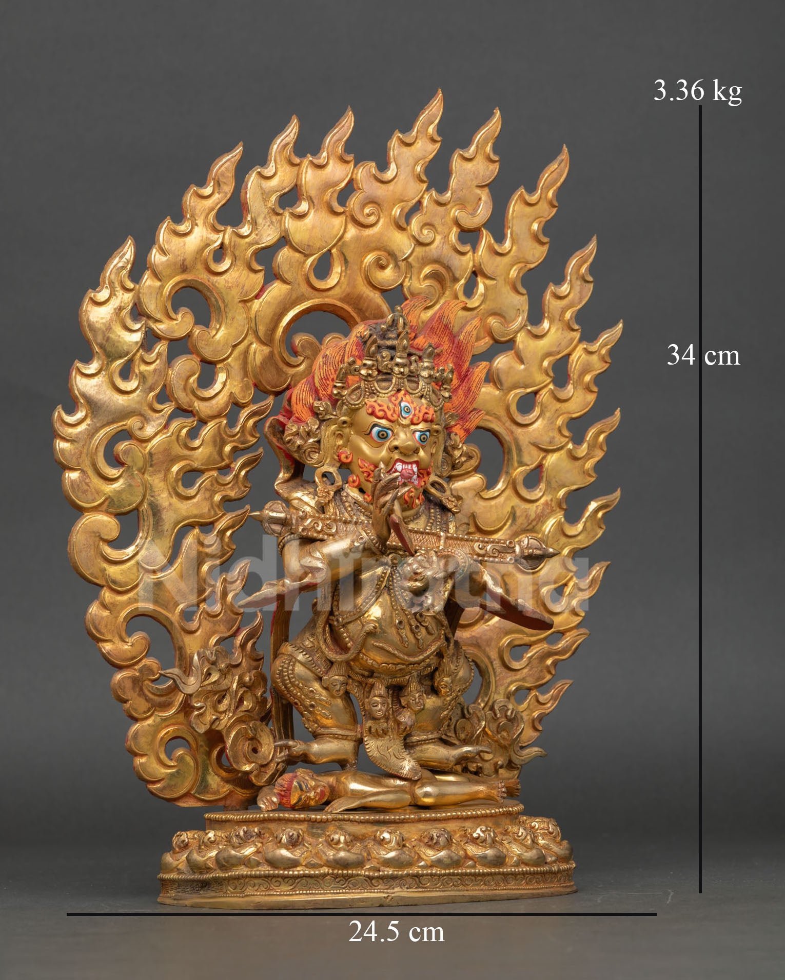 Side view of Sakya Mahakala statue showing lotus seat human figure subjugation and flaming halo design