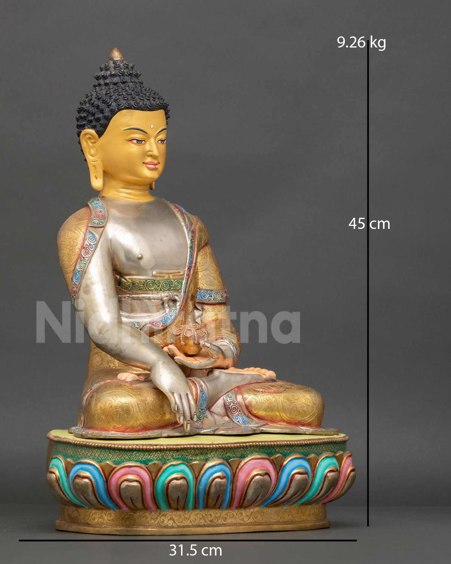 Side view of seated Buddha Shakyamuni statue with copper body, gold gilding, and silver-plated ornament details