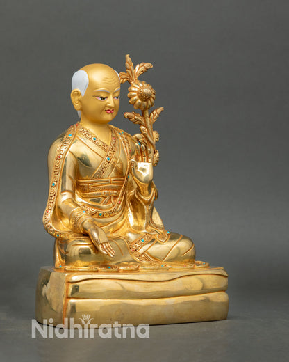Side view of Sakya Masters figures in serene posture holding sacred objects with refined Nepalese craftsmanship and traditional gold detailing