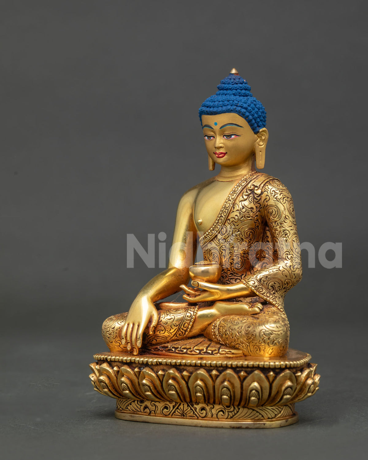 Side view of Shakyamuni buddha statue holding begging bowl in left hand.