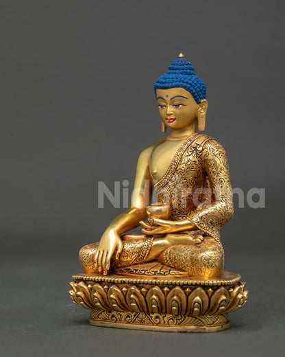 Side view of Shakyamuni buddha statue holding begging bowl in left hand.
