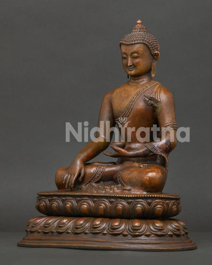 Side view of Shakyamuni Buddha statue showing handcarved robe details and oxidized copper craftsmanship.