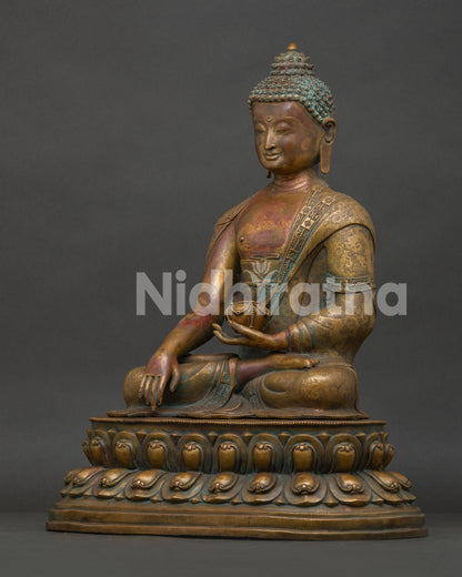 Side view of Shakyamuni Buddha statue showing intricate monk robe and double lotus pedestal.