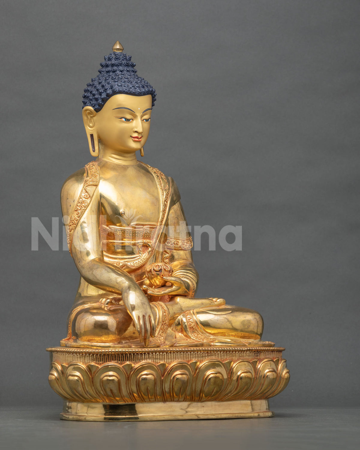 Side view of Shakyamuni Buddha statue with Earth Touching Mudra and alms bowl on a lotus pedestal