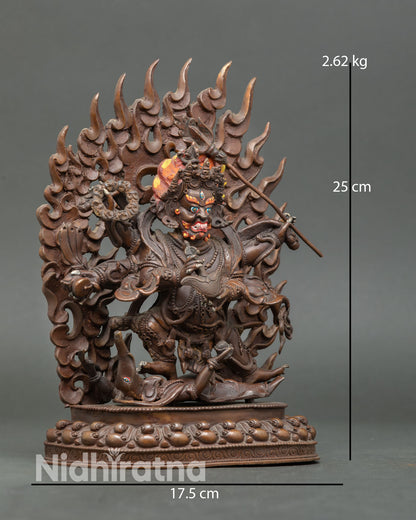 Side view of Six-Armed Mahakala with six arms holding sacred implements, tiger skin robe, standing on lotus seat, oxidized copper Vajrayana guardian deity sculpture.
