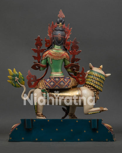 Side view of snow lion base beneath Simhanada Green Tara sculpture
