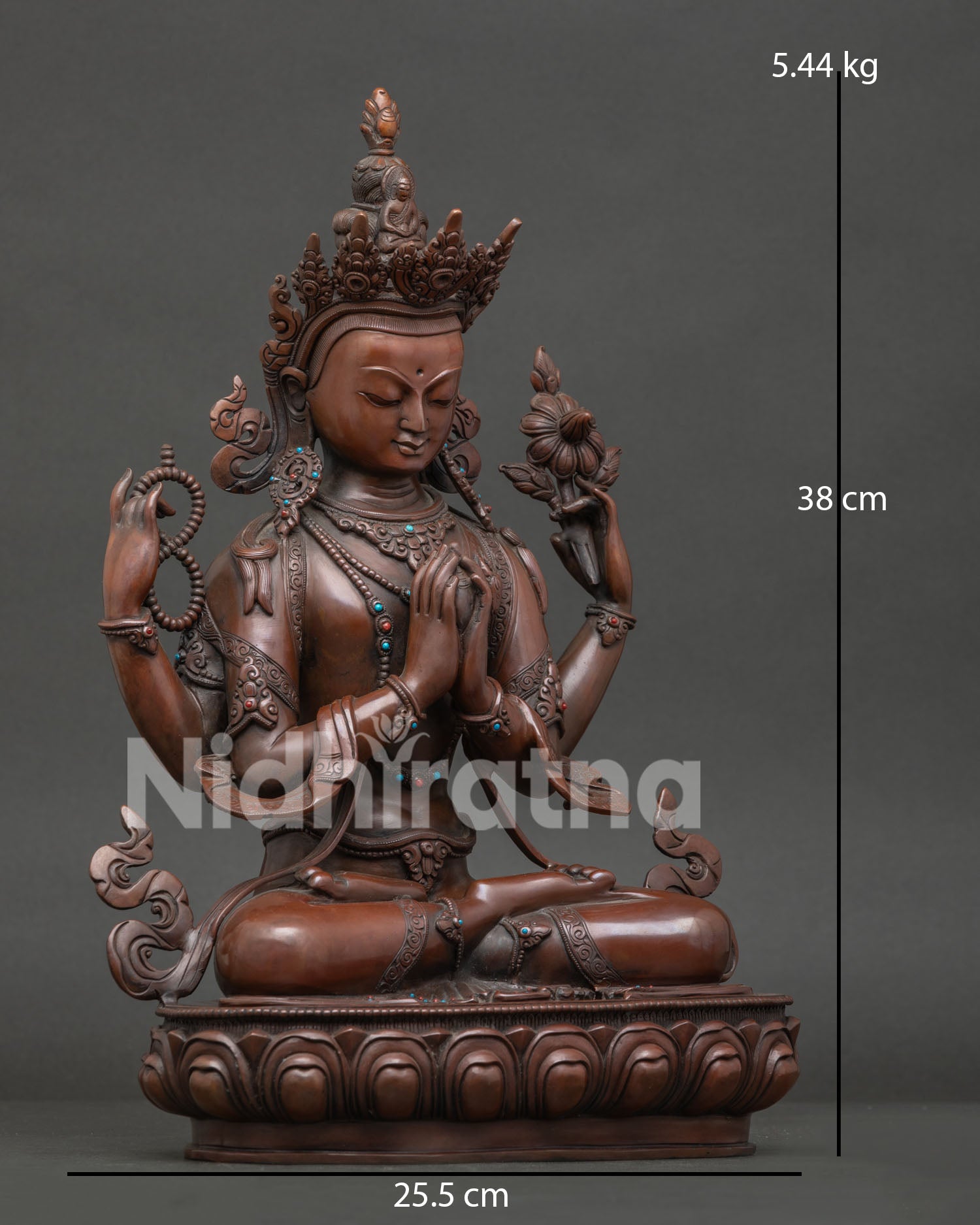 Side view of Tibetan Chenrezig statue holding crystal mala and utpala lotus flower