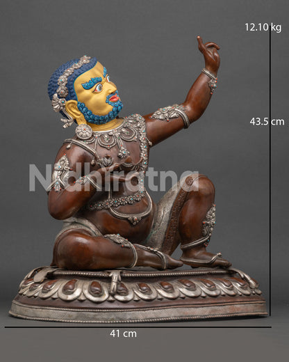 Side View of Tibetan Virupa Statue Holding Skull Cup and Raised Hand in Tantric Gesture on Lotus Pedestal