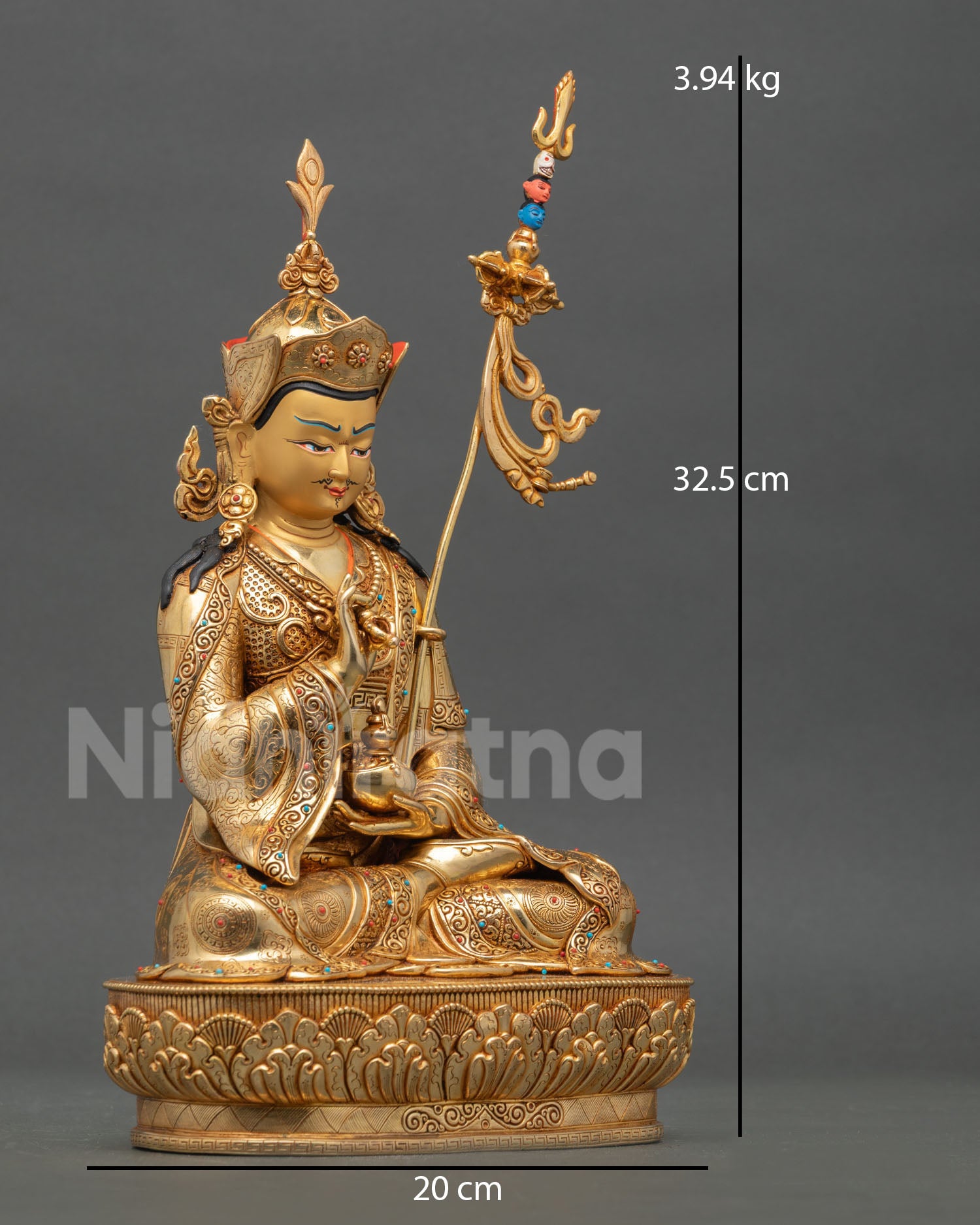 Side view of Tsokye Dorje statue seated on blooming lotus holding dorje and skull cup representing wisdom transformation and protection