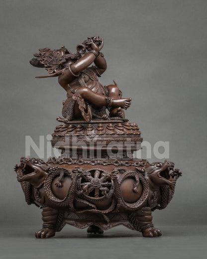 Side view of Vajradaka statue on dragon-carved incense burner base