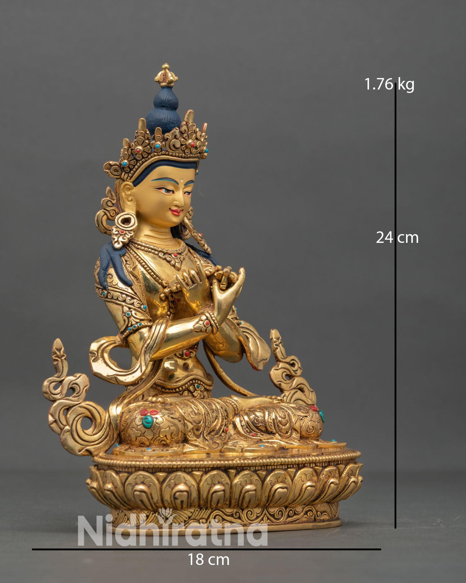 Side view of Vajradhara statue holding vajra and bell representing union of wisdom and method in Vajrayana Buddhism