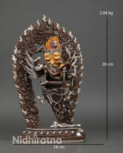 Side view of Vajrakilaya statue holding phurba, vajra, and ritual knife, a tantric deity for meditation decor.