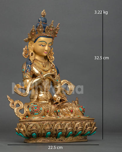 Side view of Vajrasattva holding vajra and bell with flowing robes and semi precious stones