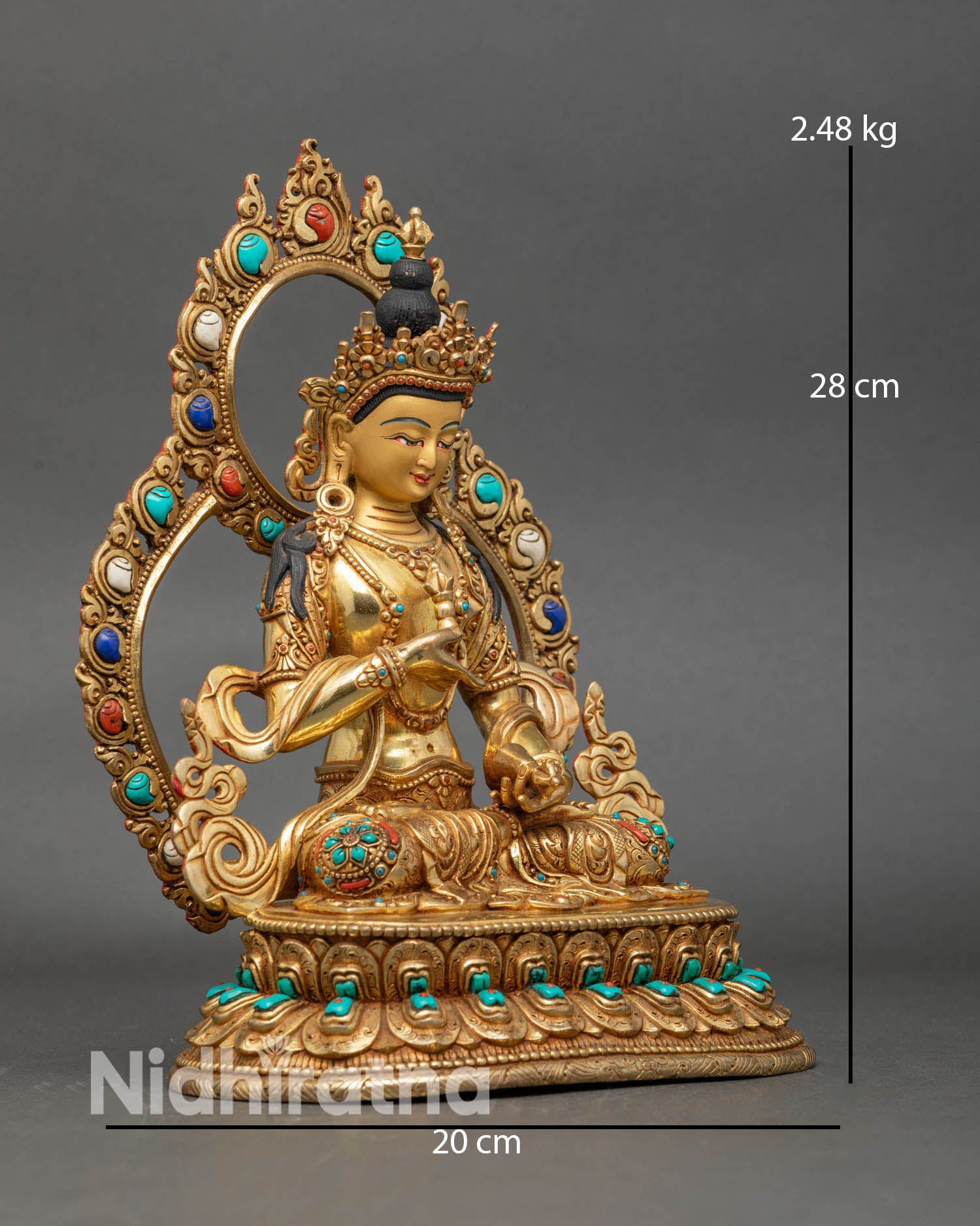 Side view of Vajrasattva statue, holding vajra and bell, with floral robes and spiritual energy decor.