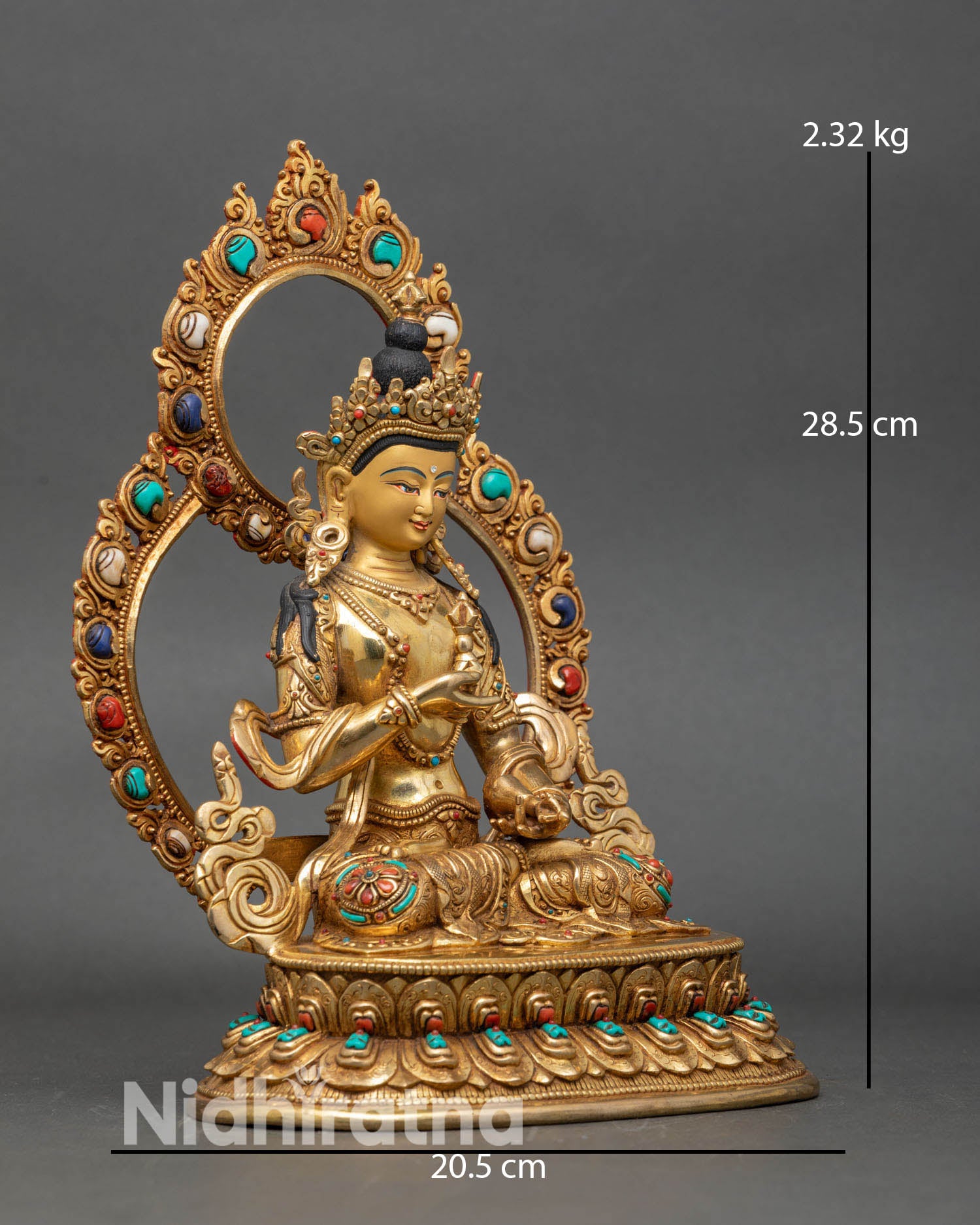 Side view of Vajrasattva statue, holding vajra and ghanta with floral robes and semi-precious stones