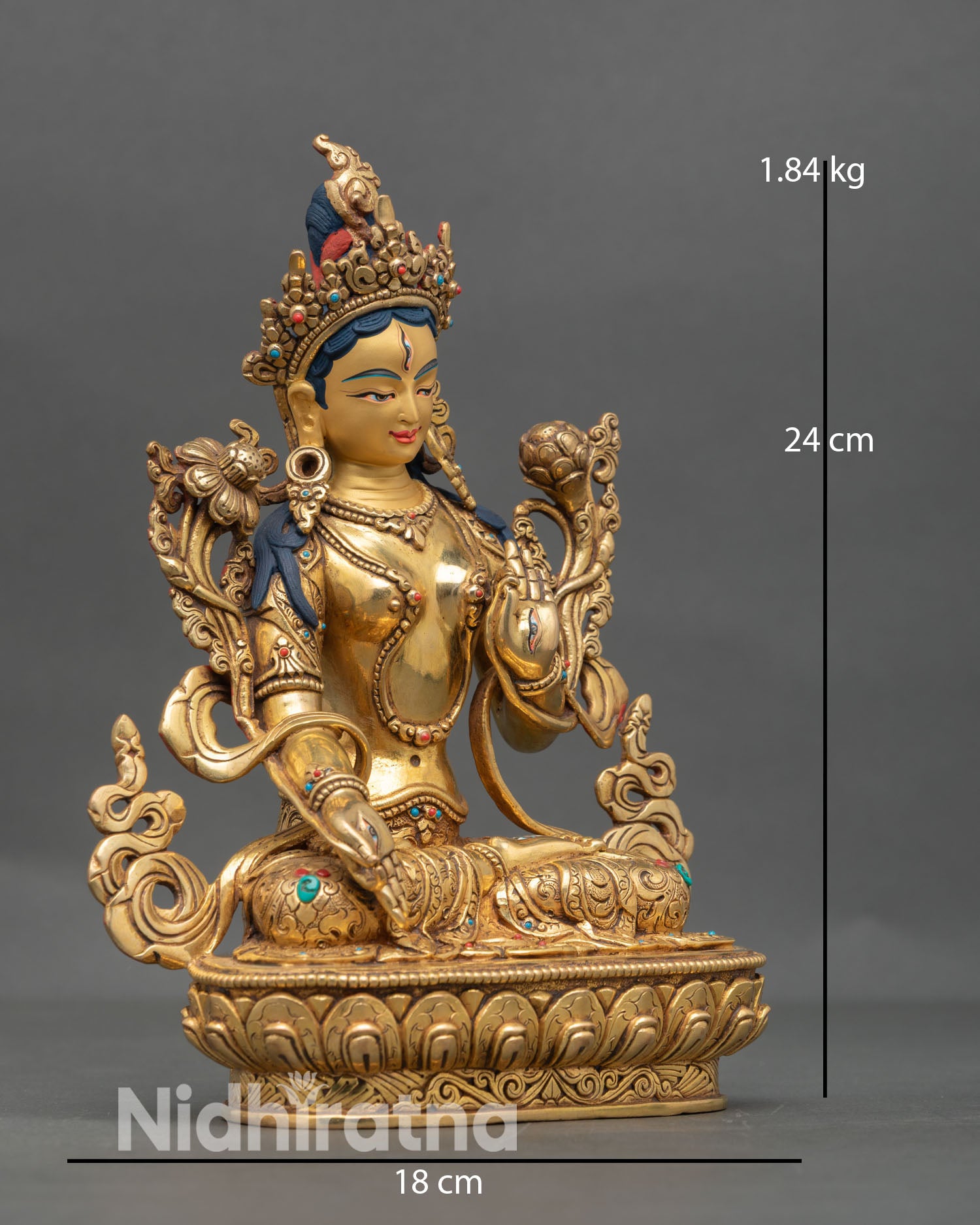 Side view of White Tara Buddhist goddess statue seated in calm posture on lotus throne with graceful detailing symbolizing healing and longevity