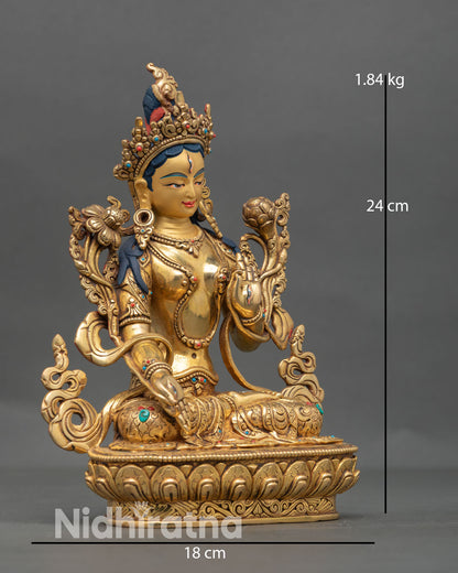 Side view of White Tara Buddhist goddess statue seated in calm posture on lotus throne with graceful detailing symbolizing healing and longevity