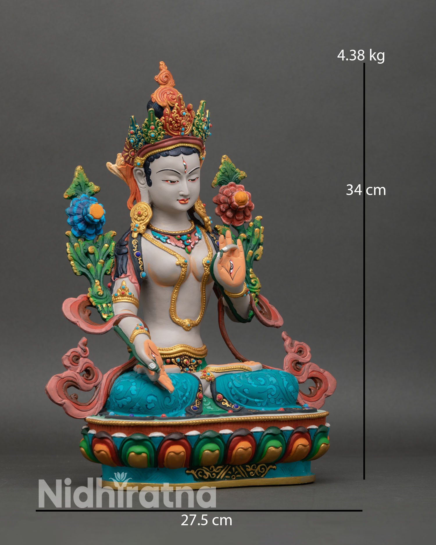 Side view of White Tara seated on lotus in peaceful posture with multicolored robes, spiritual healing deity statue
