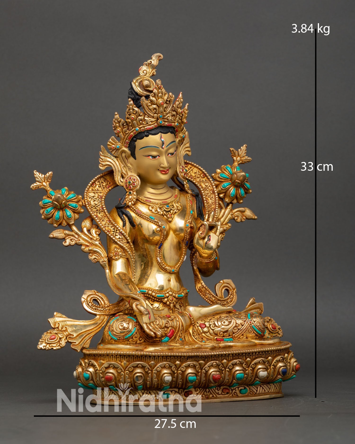 Side view of white tara statue holding utpala lotus varada mudra for compassion