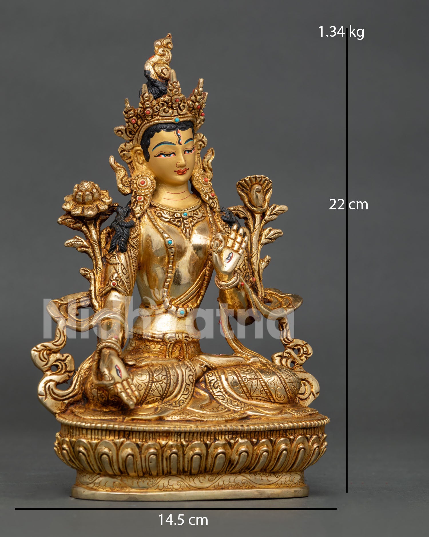 side view of white tara statue showing vajra posture blessing hand and lotus