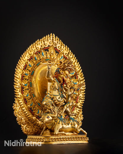 Side view of Yamantaka with consort showing intricate halo detailing in gold gilded copper tantric Buddhist artwork.