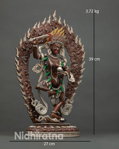 Side view of Yeshe Walmo with sword and vase copper wrathful goddess statue handmade Patan Nepal.