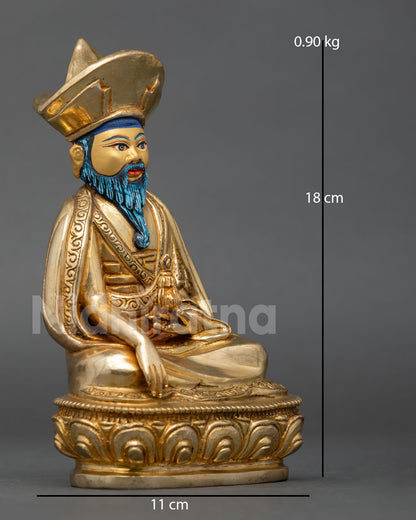 Side view of Zabdrung Rinpoche statue in meditative posture performing earth touching mudra holding ritual vase