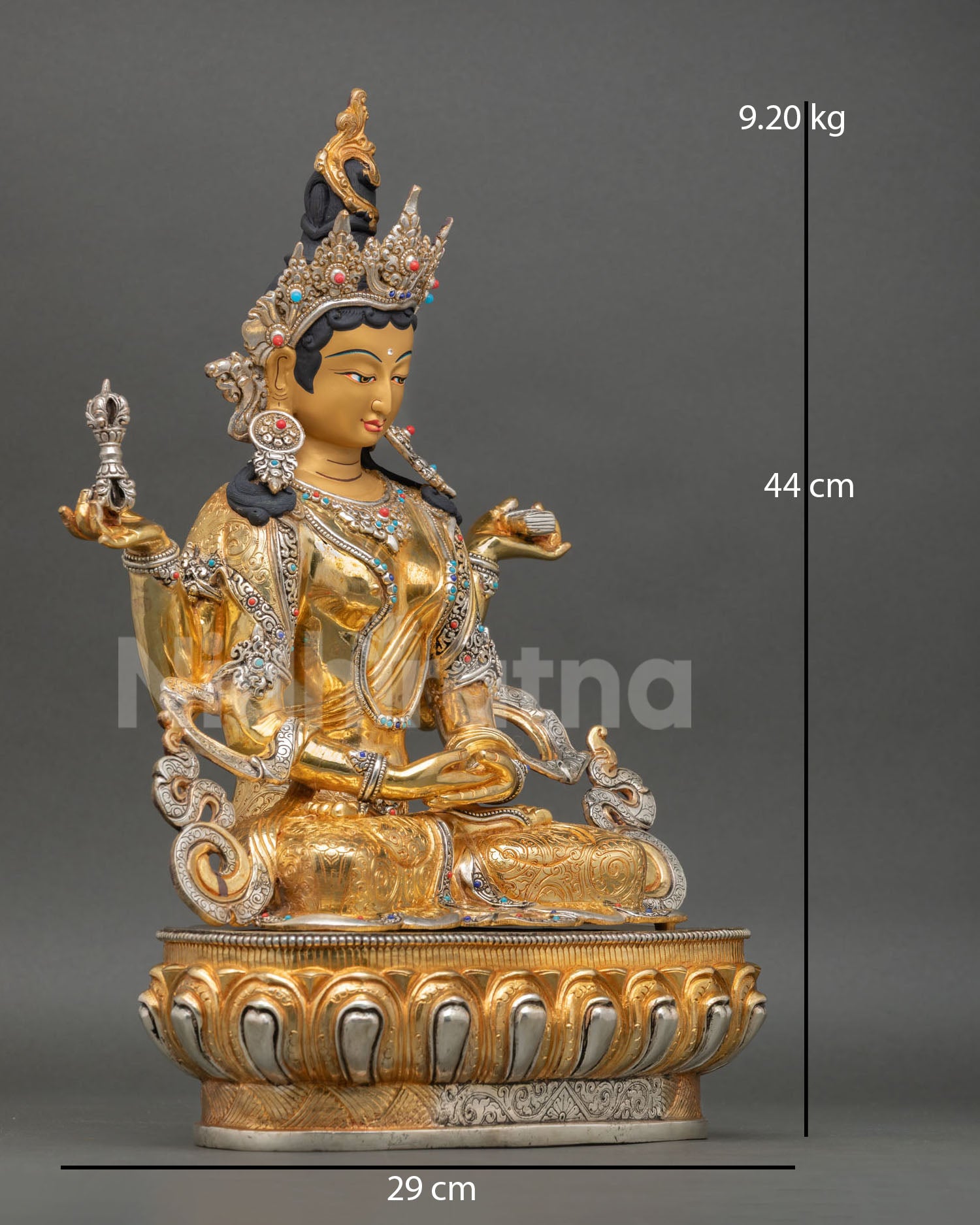 Side view of Prajnaparamita copper statue with vajra and sutra Tibetan deity