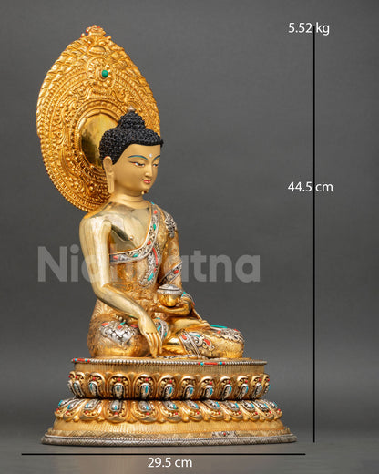 Side view of Shakyamuni Buddha meditation statue seated on lotus pedestal copper handcrafted Nepal Buddhist deity sculpture spiritual altar decor