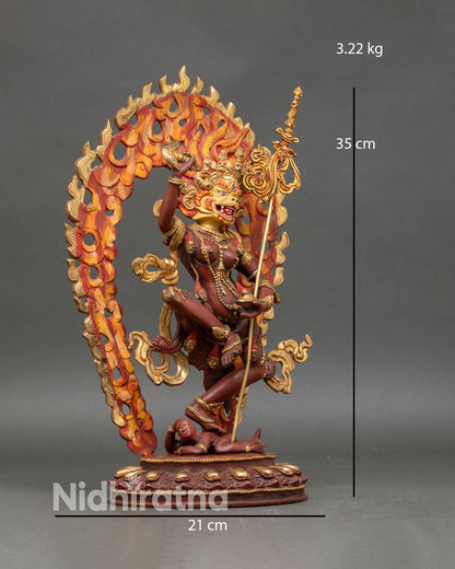 Side view of Simha Mukha statue, robes, kartika trident skull, cup, sacred deity