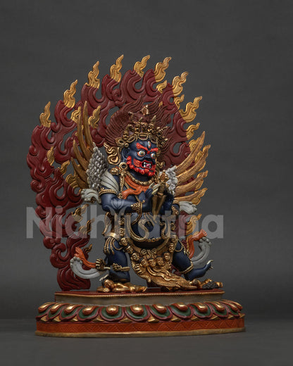 Side view vajrakilaya statue showing silver plated wings skull garland and ornaments.