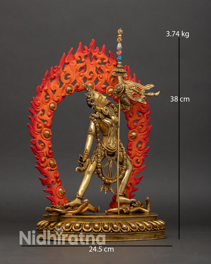 Side view Vajrayogini tantric goddess statue flowing robes flaming halo skull motifs trident shoulder dynamic posture Buddhist sculpture Nepal.
