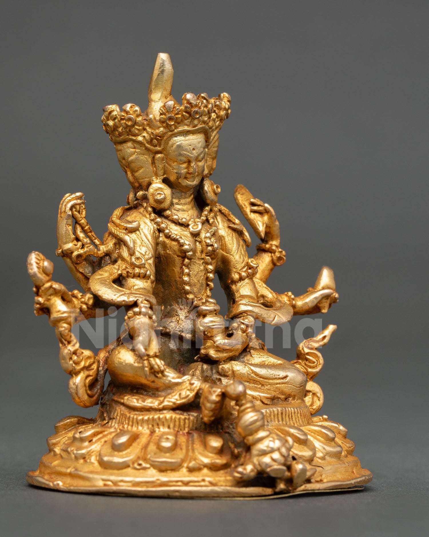 Side view of Vasudhara Buddhist wealth goddess statue Newari craftsmanship copper sculpture meditation shrine spiritual abundance decor